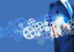 Managed IT Services - A business man pointing digital gears