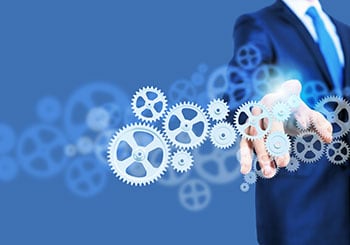Managed IT Services - A business man pointing digital gears