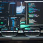 The-Difference-Between-Exploits-and-Vulnerabilities-1 A pair of glasses on a laptop.