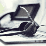 Headphones on a laptop representing VoIP Phone services