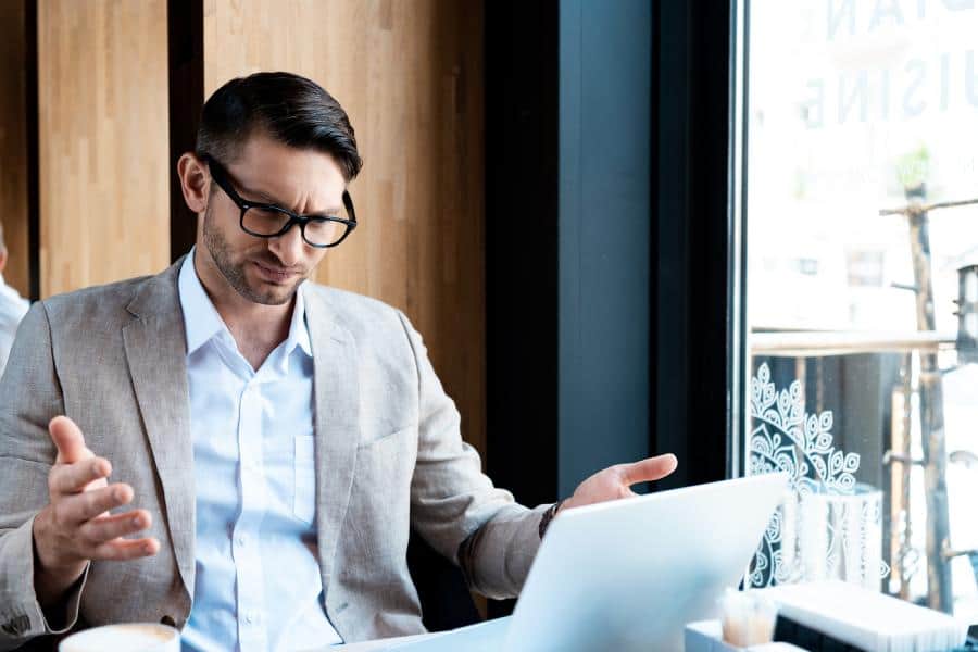 A man looking confused trying to figure out managed IT support pricing in Portland.