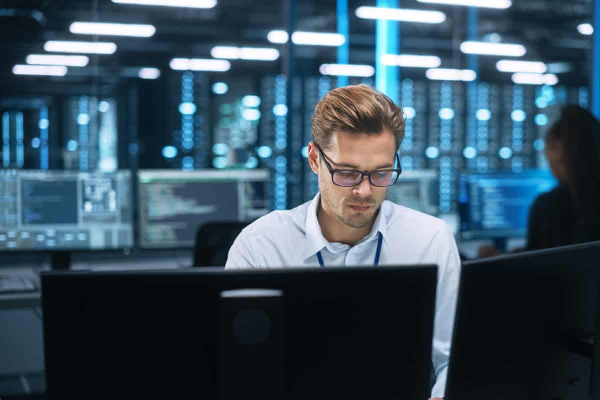 Two IT Specialists walking in a server room