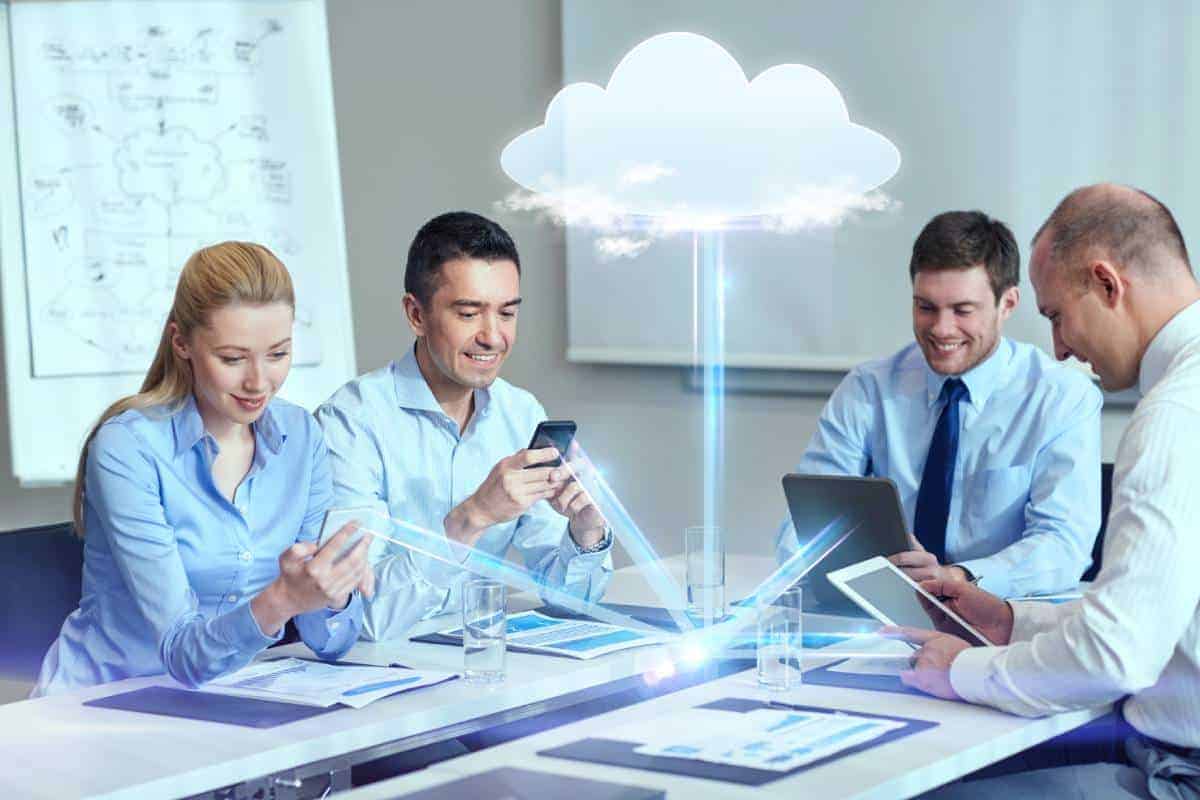 A Portland IT support team strategizing over digital cloud technology at a table.