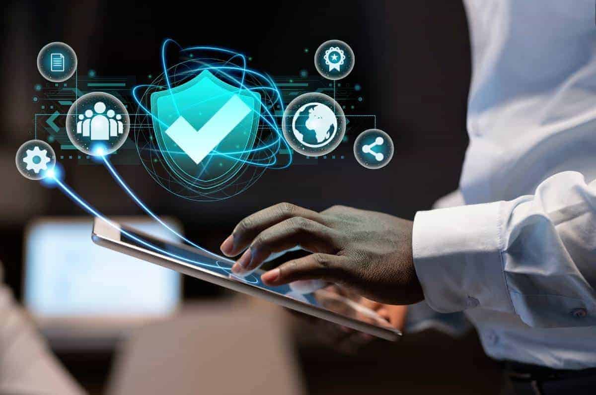 A San Jose cybersecurity expert using digital tablet with security icons hologram.