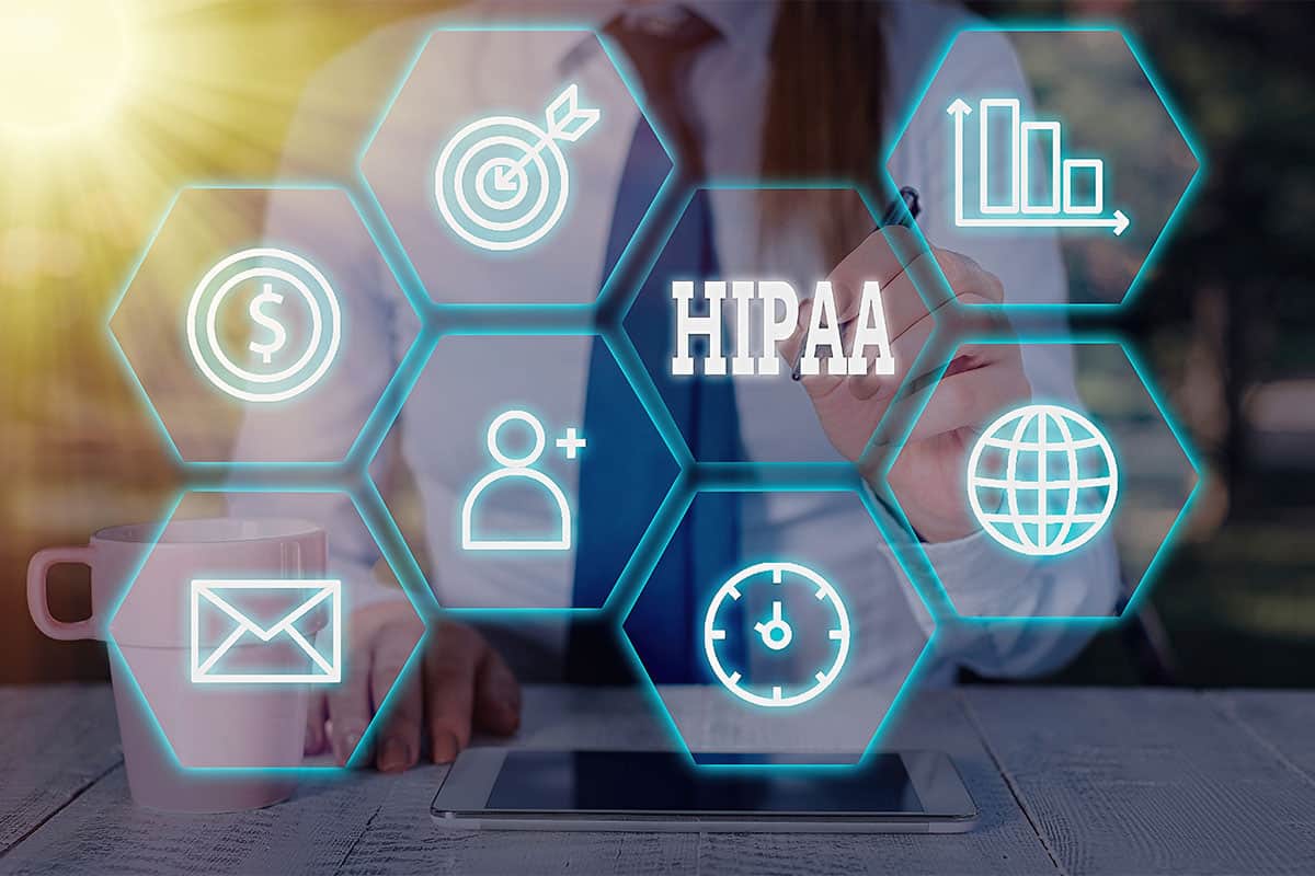 A professional working on Portland HIPAA compliance with a digital interface.