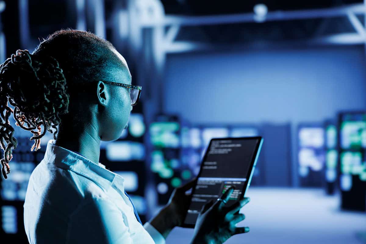 A system administrator builds firewall protection in a server room housing advanced infrastructure.