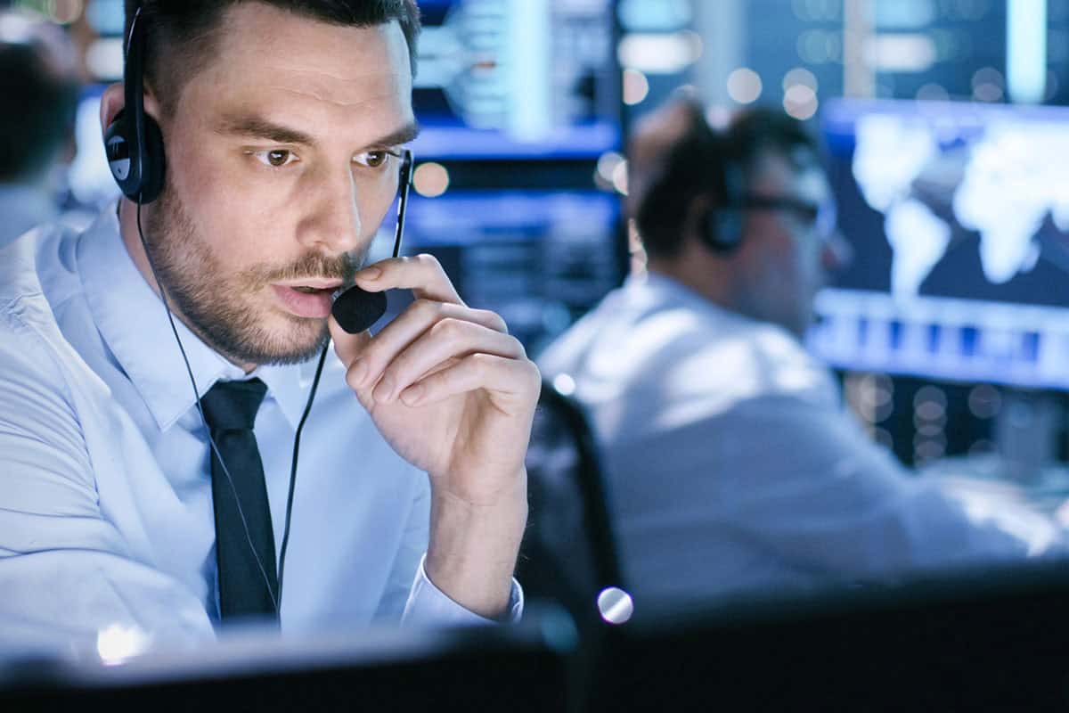 A tech support specialist is in a call center on a call with a client.