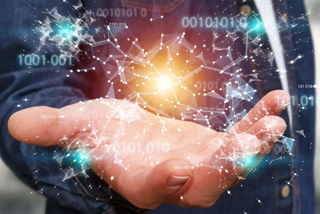 A businessman is holding out his hand to reveal a 3D render of connected nodes and binary code.
