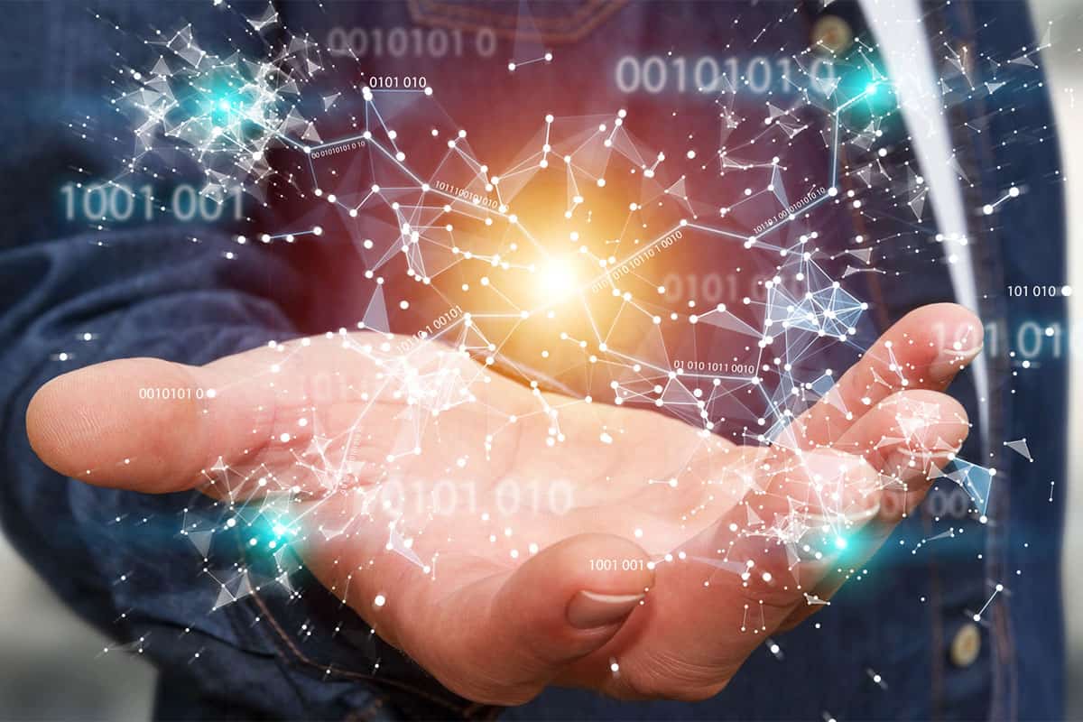 A businessman is holding out his hand to reveal a 3D render of connected nodes and binary code.